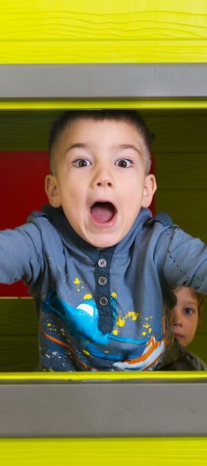 little boy in playhouse