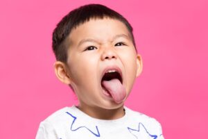 little boy sticking out tongue