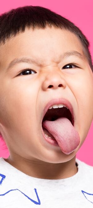 little boy sticking out tongue