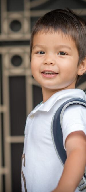 little boy with backpack on