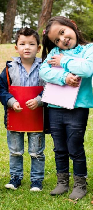little children outside with notebooks
