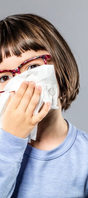 little girl blowing her nose