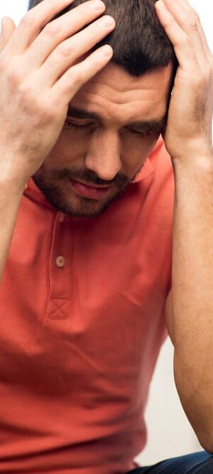 man with hands on head