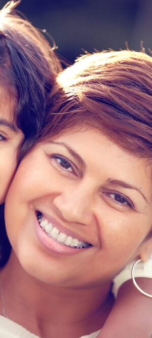 mom and daughter smiling at park