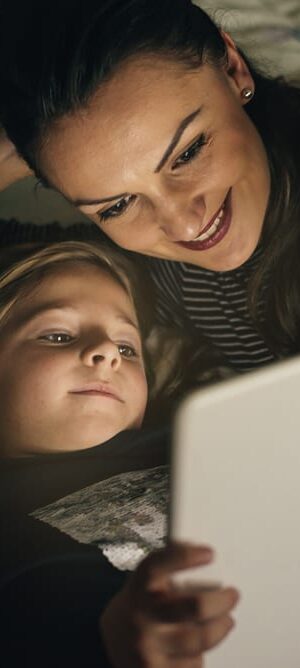 mom and girl looking at tablet