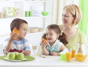 mom and kids eating fruit