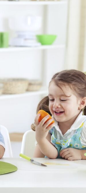 mom and kids eating fruit