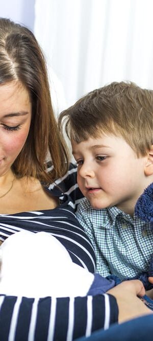 mom breastfeeding newborn with boy