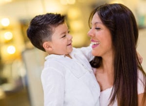 mom hugging little boy