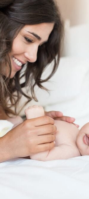 mom with newborn on bed