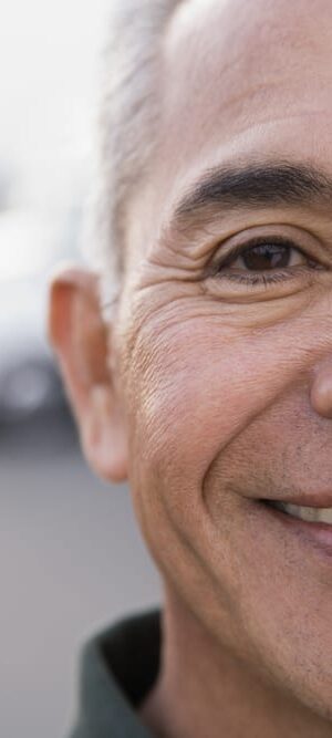 older man smiling outdoors