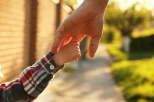 photo of parent holding child hand