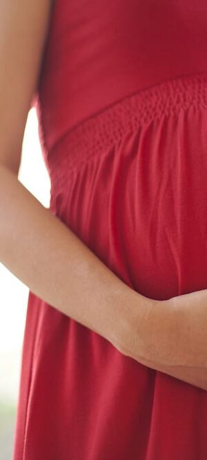 pregnant belly in red dress