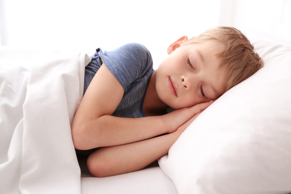 sleeping boy in bed - Wyoming Department of Health