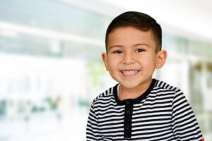 smiling boy in striped shirt