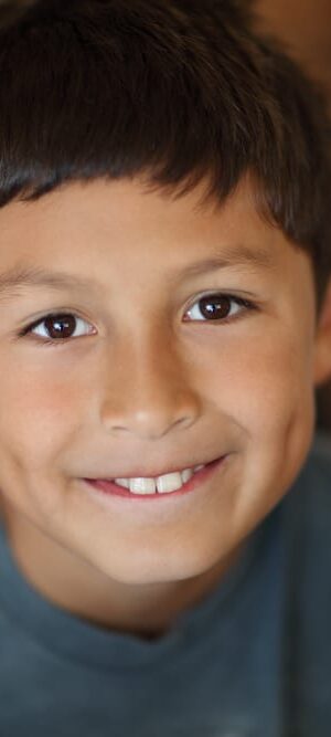 smiling boy with big brown eyes