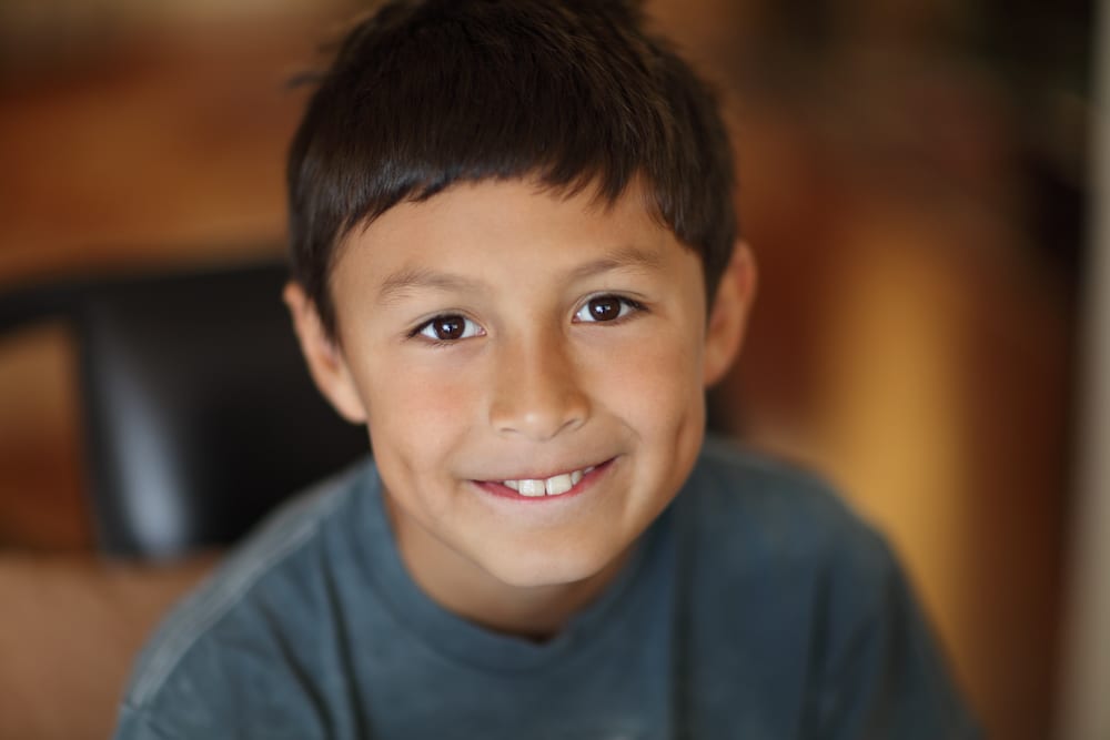 smiling boy with big brown eyes - Wyoming Department of Health