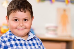 smiling boy with chubby cheeks - Wyoming Department of Health