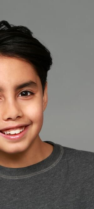 smiling boy with gray shirt
