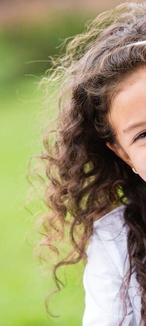 smiling girl with curly hair