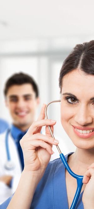 smiling nurse with other medical team