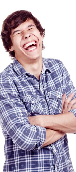 teen boy laughing indoors