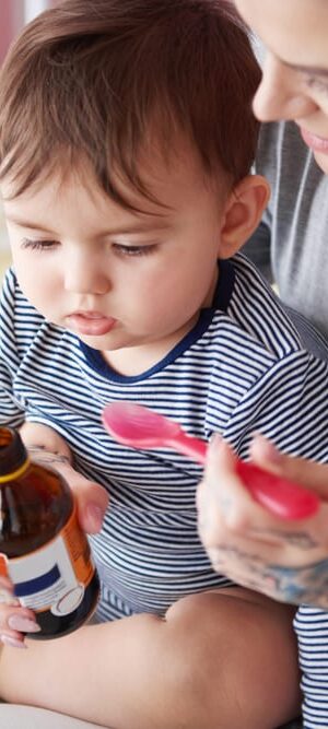 toddler taking medicine