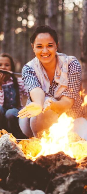 woman and girls with campfire