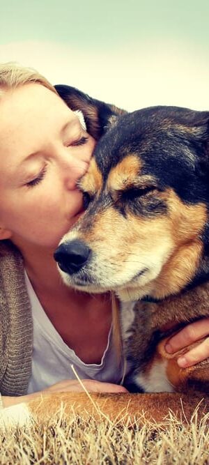 woman kissing dog