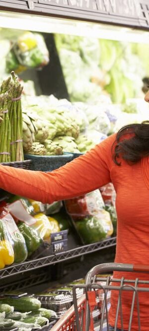woman looking at vegetables