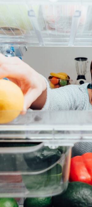 woman looking in fridge