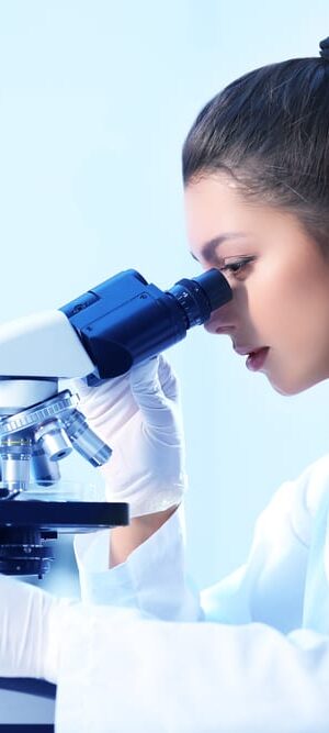 woman looking in microscope