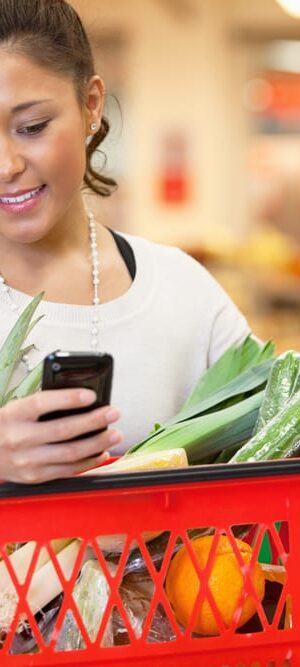 woman with phone at grocery store