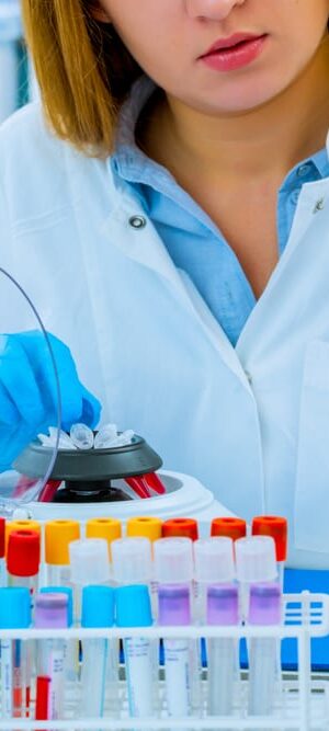 worker with lab tubes and equipment