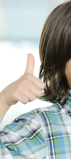 young boy with thumbs up
