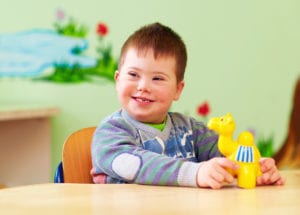 child smiling with toy