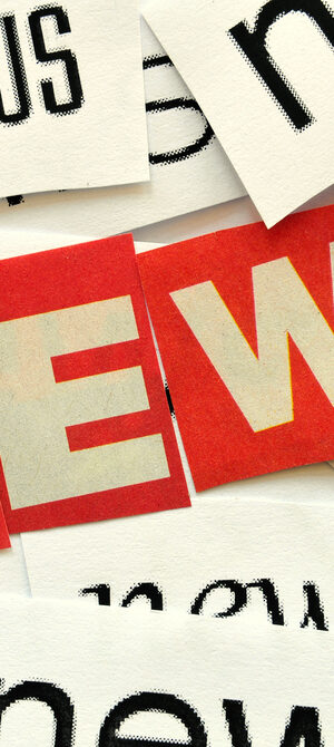 news word on sheets of paper