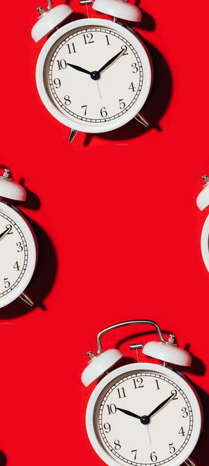 alarm clocks on red background