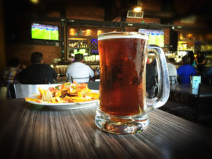 beer and nachos in a bar