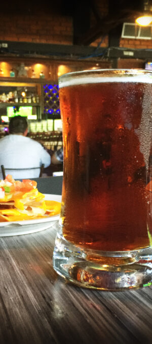 beer and nachos in a bar