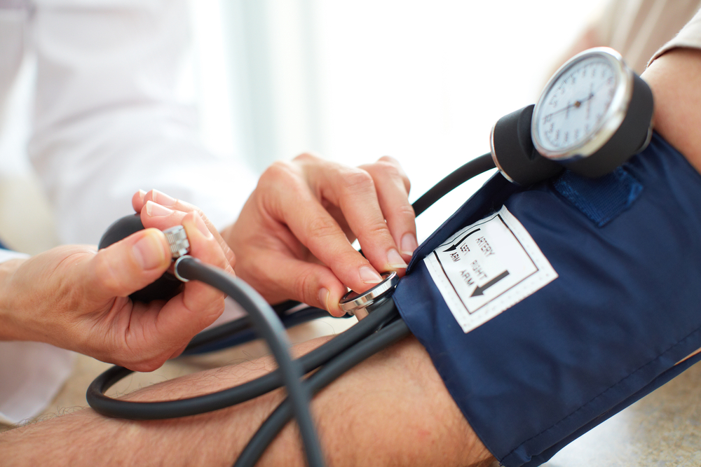 blood pressure cuff on arm - Wyoming Department of Health