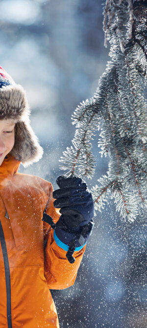 boy outside with snowy tree