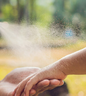 bug spray going on child’s arm