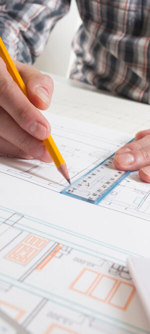 building plans with hands