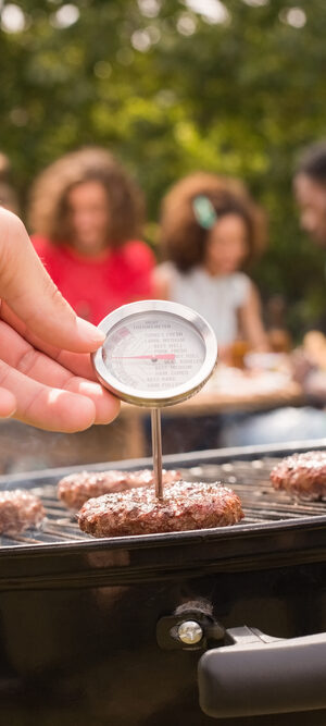 burgers on a grill with thermometer