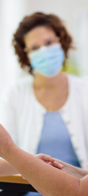 child at hospital with face covering