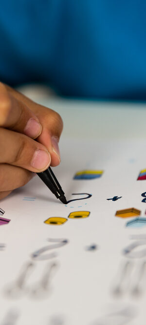 close up of kid hand doing school work