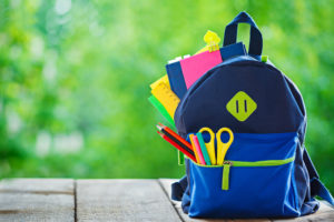 backpack with papers, scissors, pencils