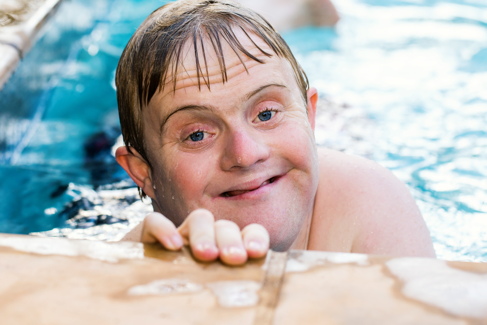 disabled man in pool smiling - Wyoming Department of Health