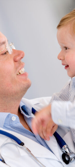 doctor holding a happy baby